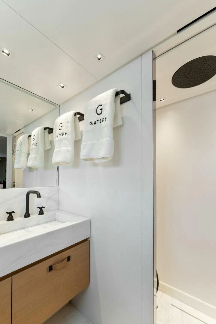 a bathroom with a sink and towels aboard GATSBY Yacht for Charter