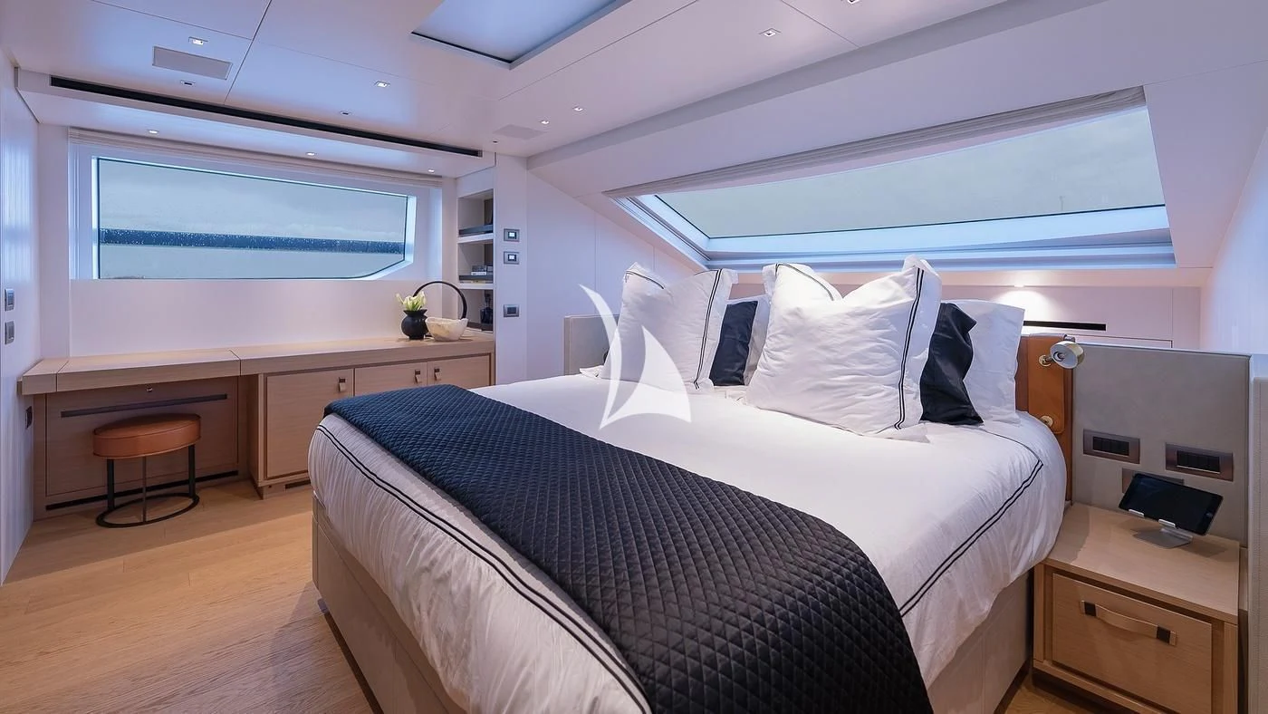 a bedroom with a bed and desk aboard GATSBY Yacht for Charter