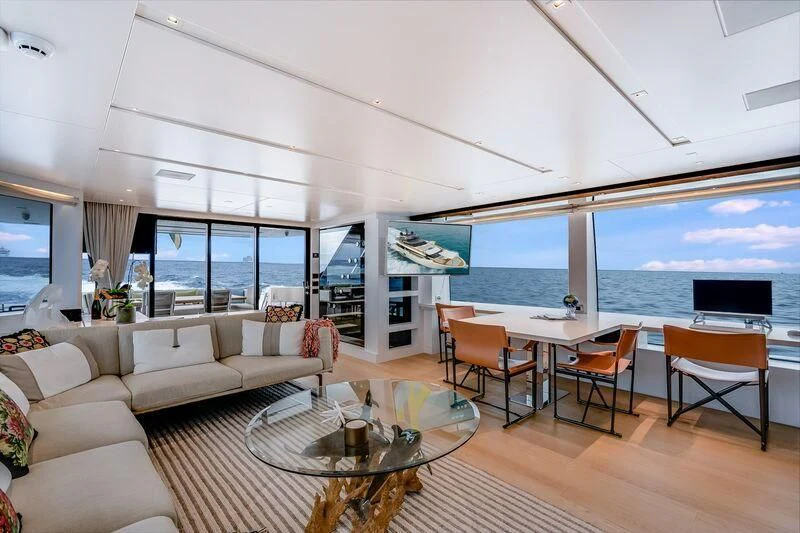 a living room with a large balcony aboard GATSBY Yacht for Charter