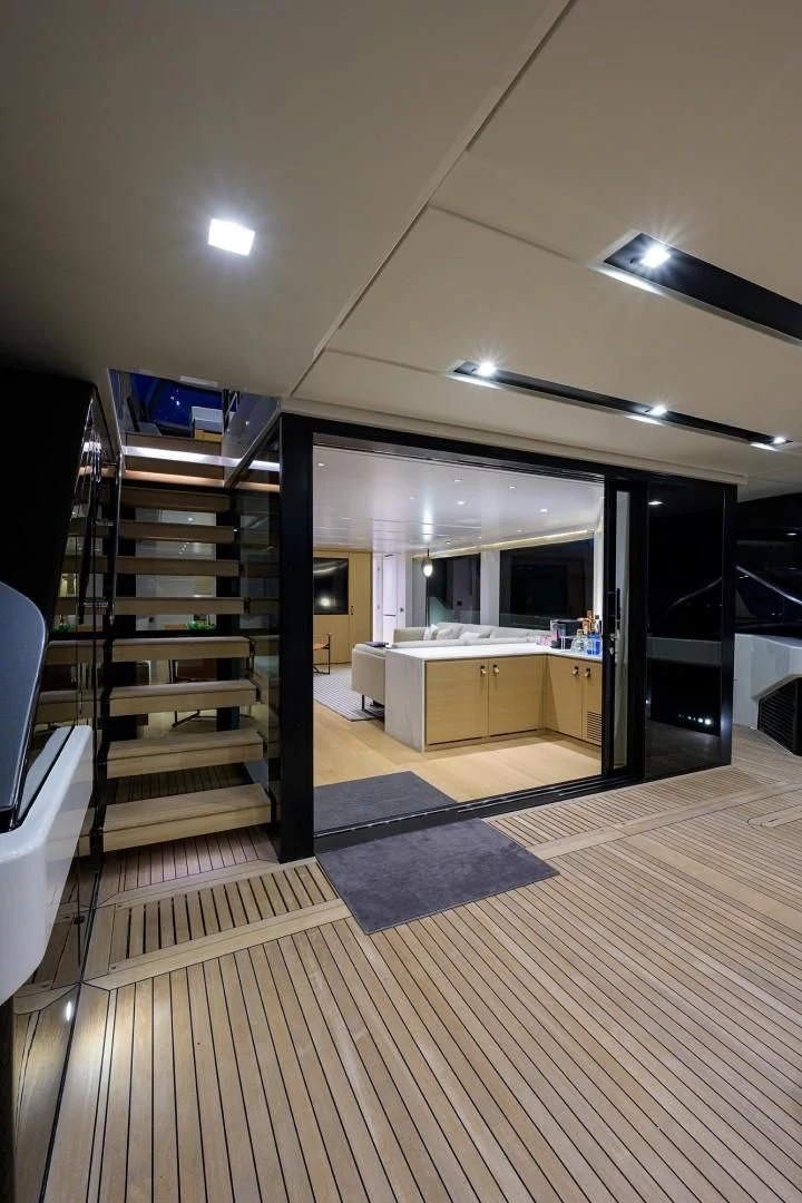 a room with a wood floor and a staircase aboard GATSBY Yacht for Charter