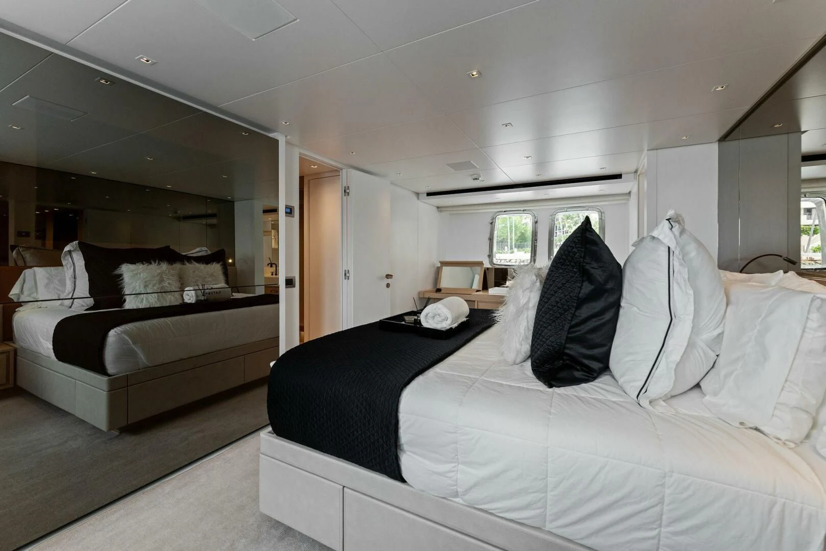 a bedroom with a bed and a large mirror aboard GATSBY Yacht for Charter