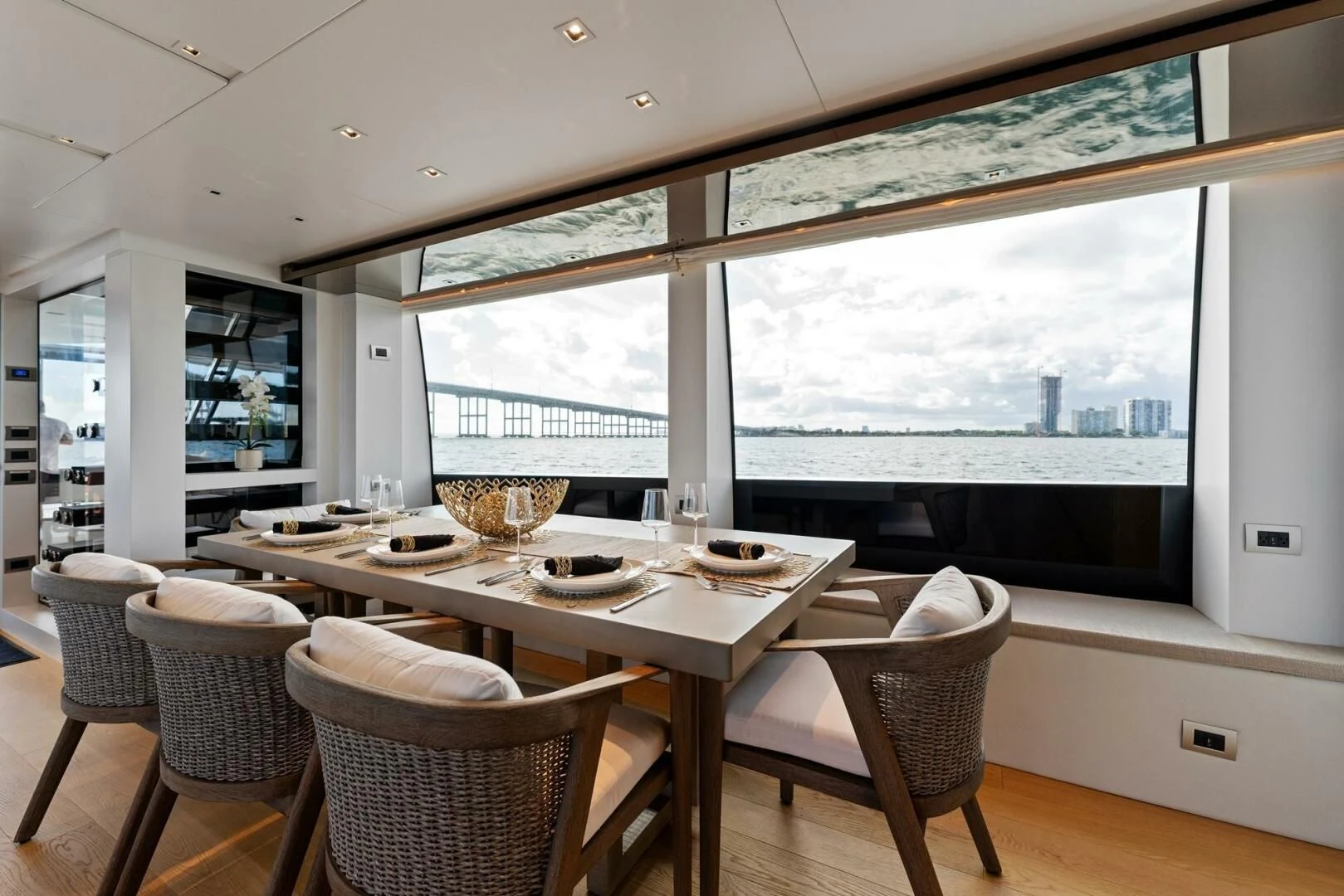 a dining room with a large window aboard GATSBY Yacht for Charter