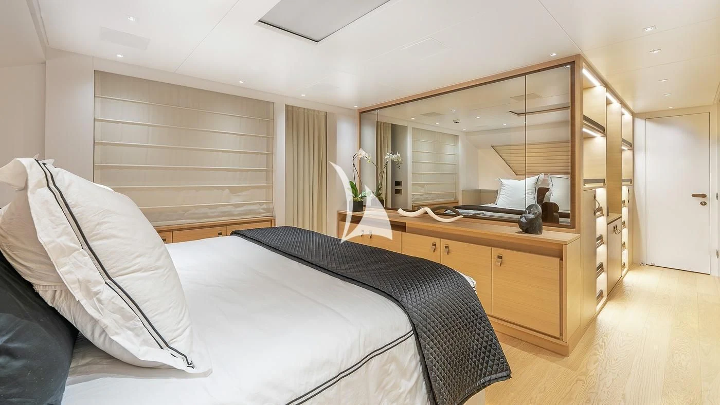 a bedroom with a bed and a desk aboard GATSBY Yacht for Charter