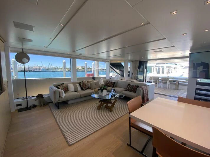 a living room with a large window aboard GATSBY Yacht for Charter