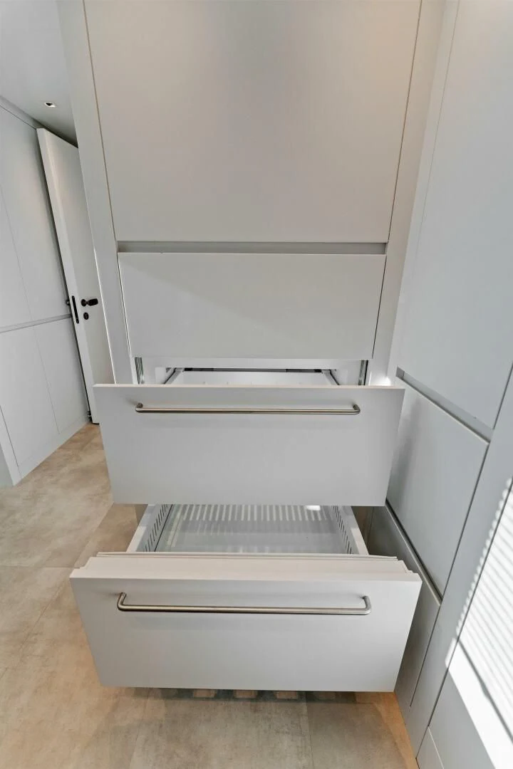 a white cabinet with drawers aboard GATSBY Yacht for Charter