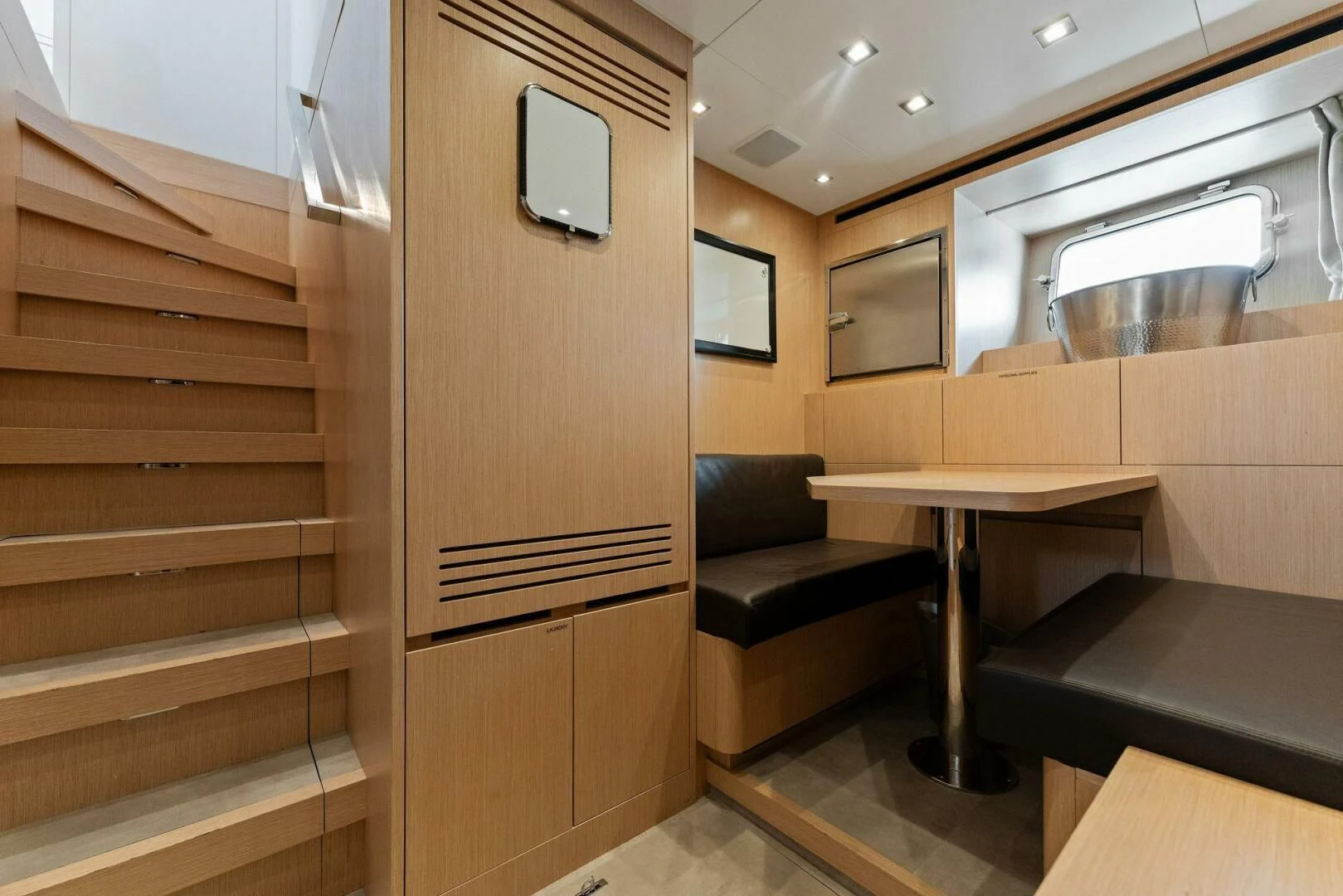 a room with a desk and a tv aboard GATSBY Yacht for Charter