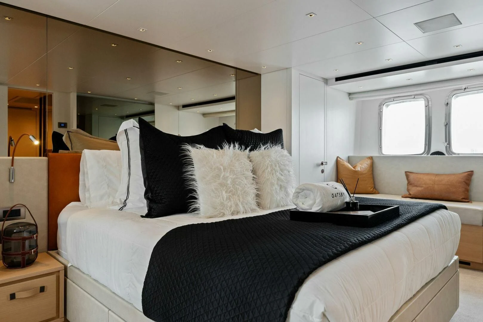 a bedroom with a bed and a couch aboard GATSBY Yacht for Charter