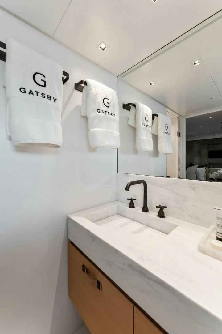 a bathroom with a sink and towels aboard GATSBY Yacht for Charter