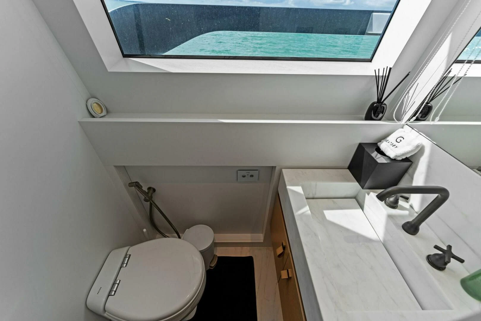 a bathroom with a sink and toilet aboard GATSBY Yacht for Charter