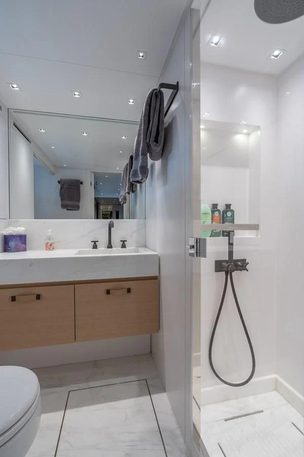 a bathroom with a sink and a mirror aboard GATSBY Yacht for Charter