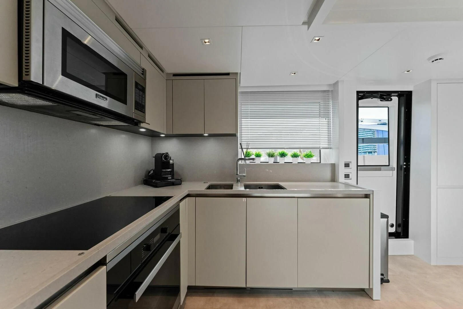 a kitchen with white cabinets aboard GATSBY Yacht for Charter