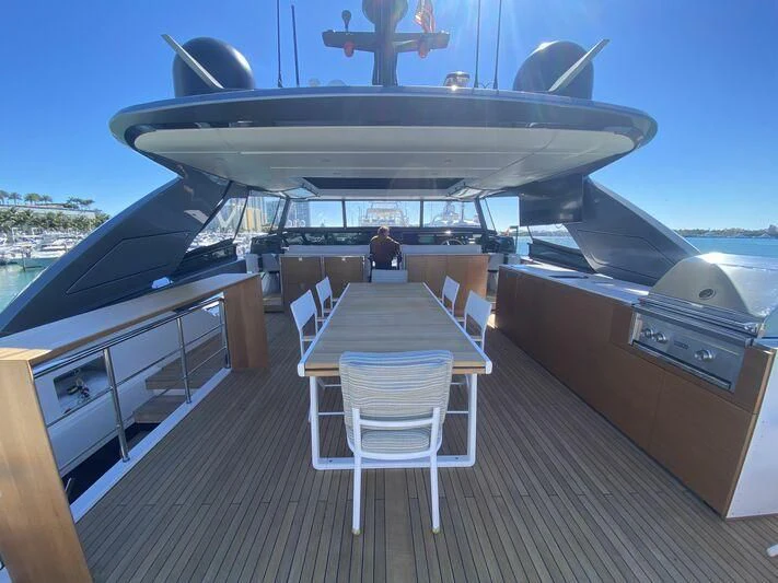 a deck with a table and chairs on it aboard GATSBY Yacht for Charter