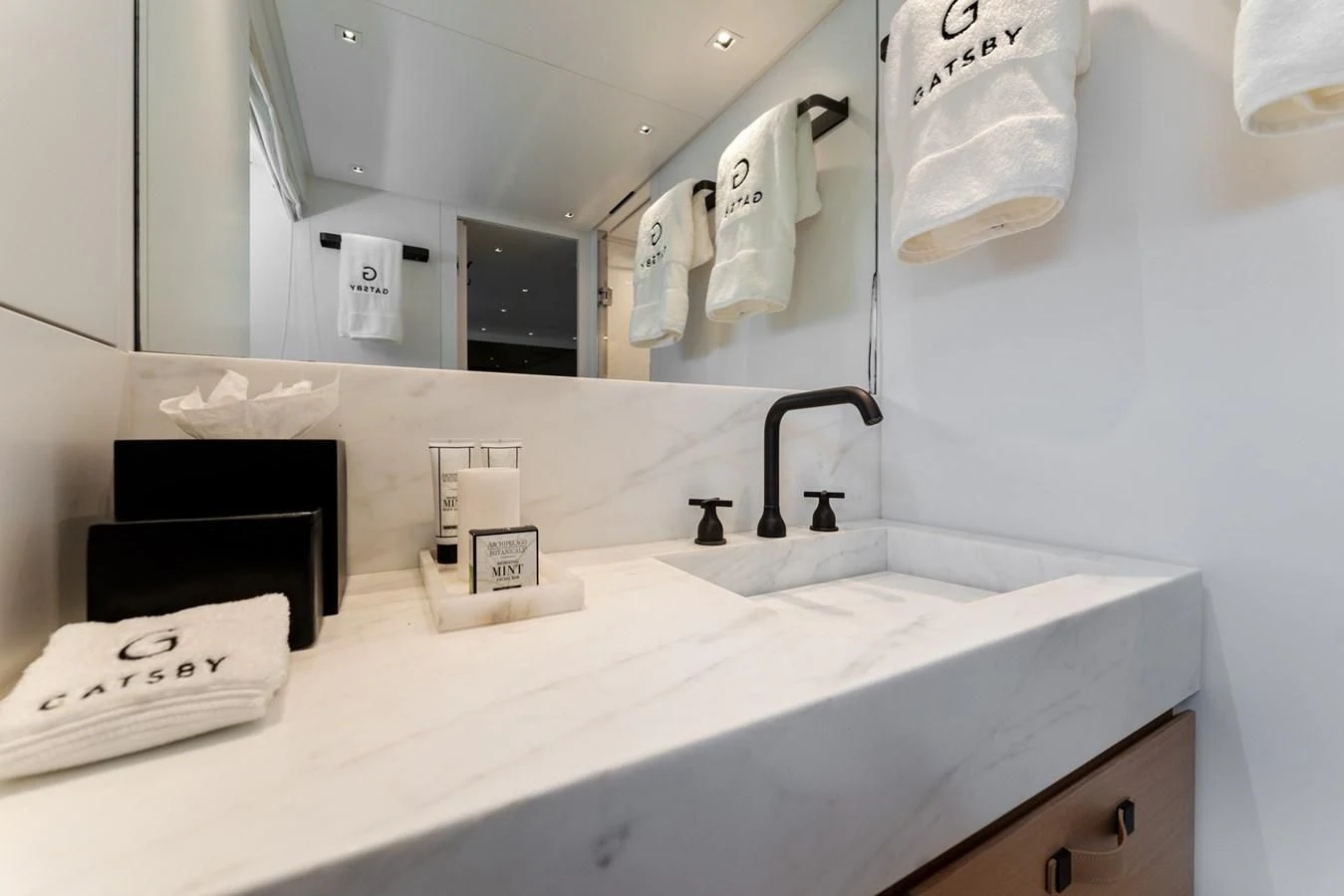 a bathroom with a large mirror aboard GATSBY Yacht for Charter