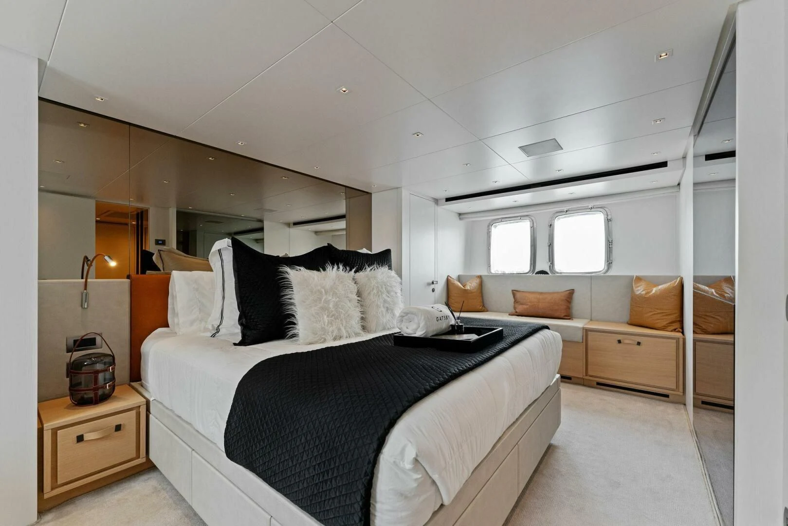a bedroom with a bed and a couch aboard GATSBY Yacht for Charter