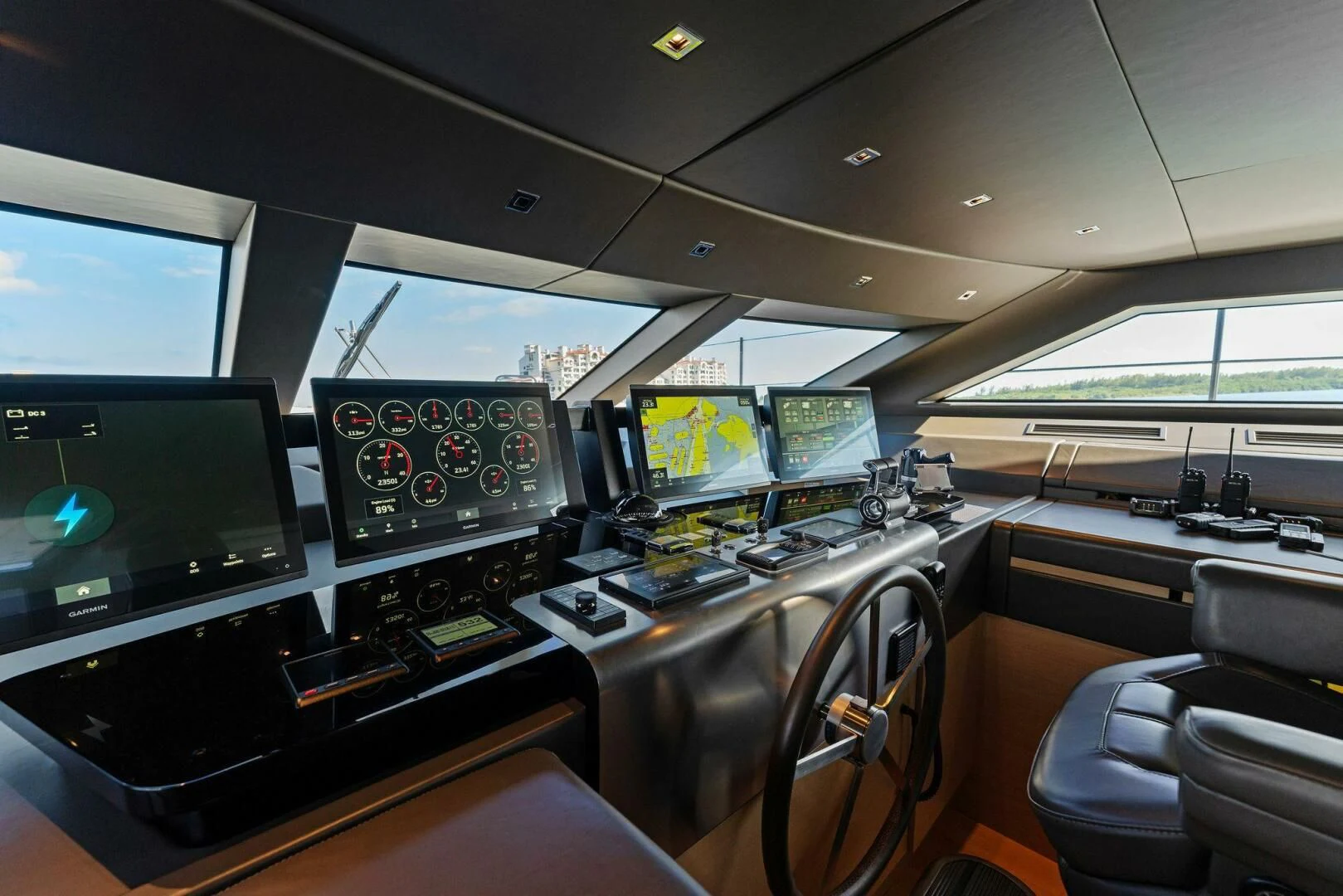 a room with many monitors and computers aboard GATSBY Yacht for Charter