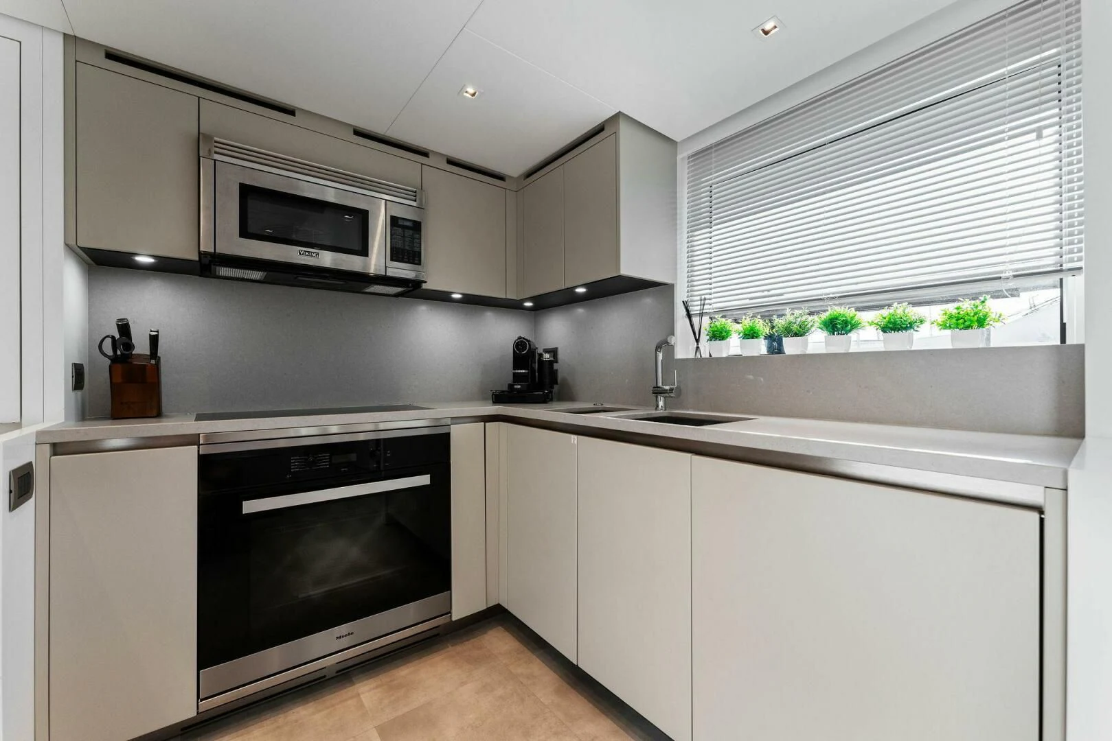 a kitchen with white cabinets aboard GATSBY Yacht for Charter