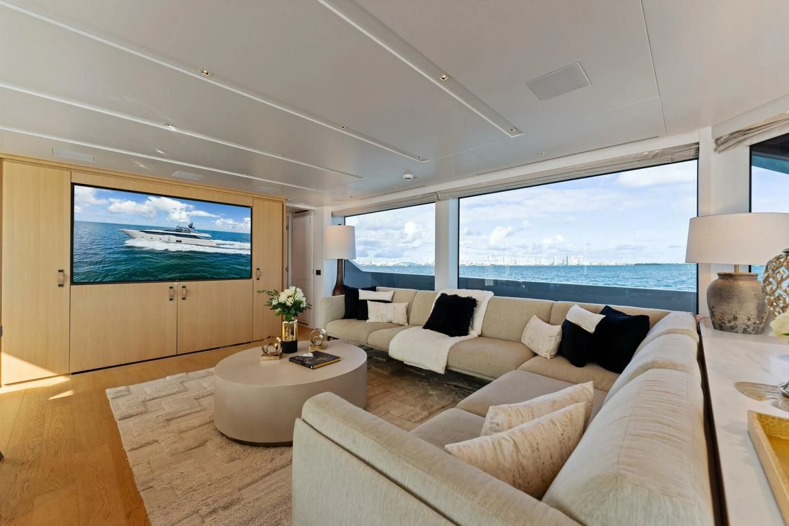 a living room with a large window aboard GATSBY Yacht for Charter
