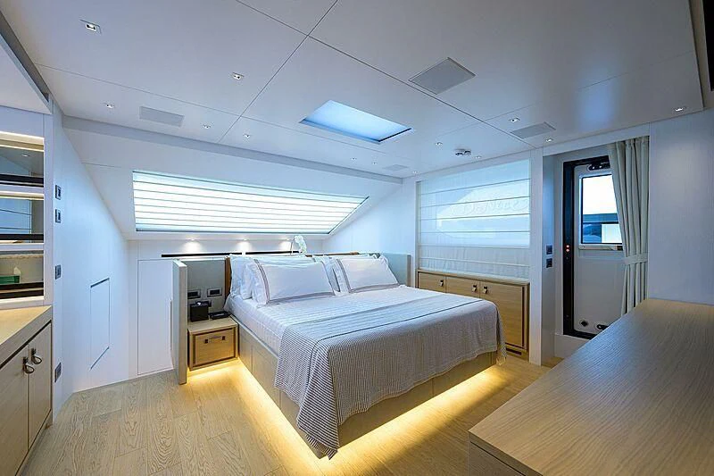 a bedroom with a bed and a desk aboard GATSBY Yacht for Charter