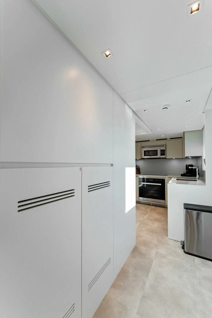 a kitchen with white cabinets aboard GATSBY Yacht for Charter