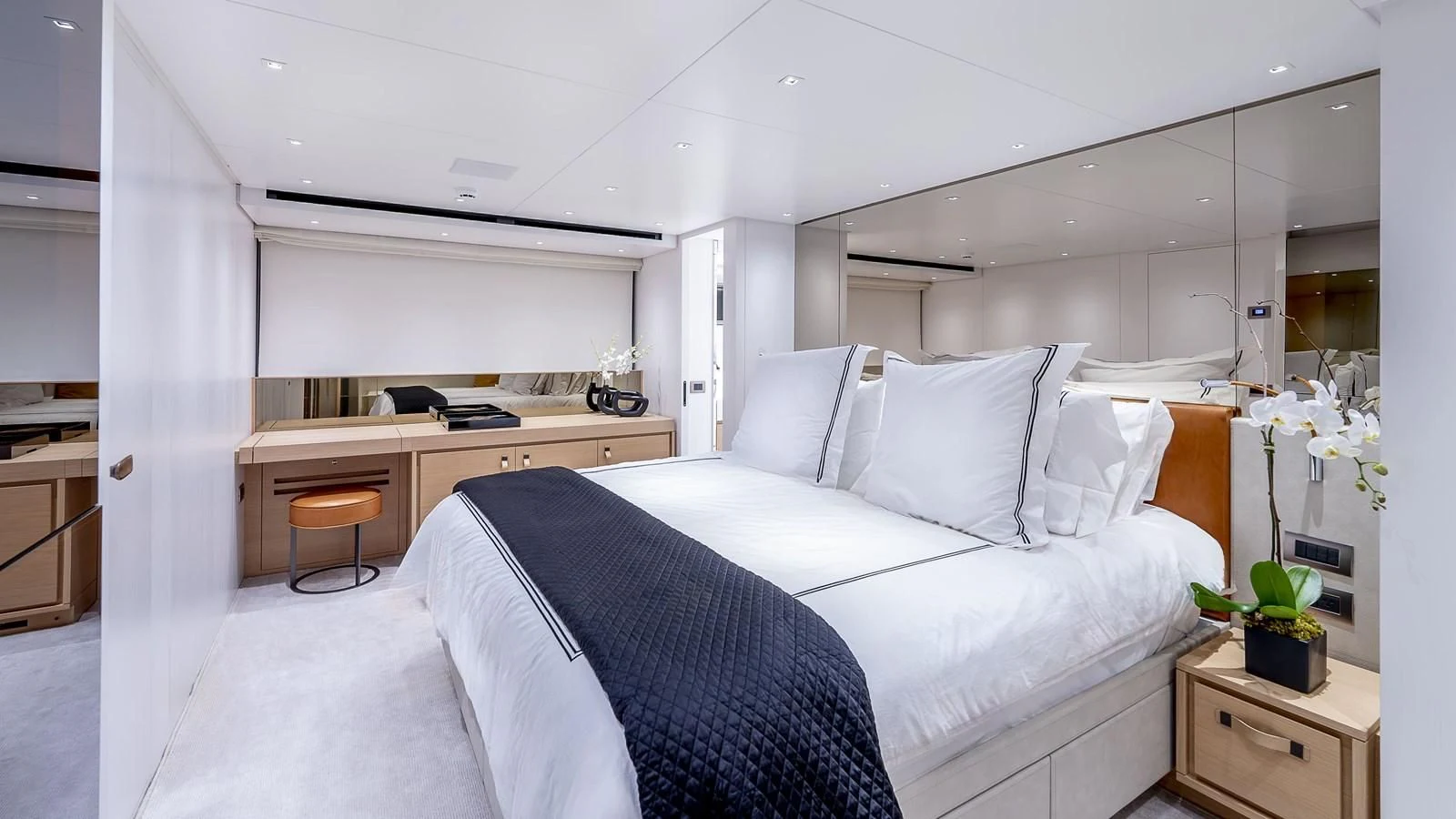 a bedroom with a bed and desk aboard GATSBY Yacht for Charter