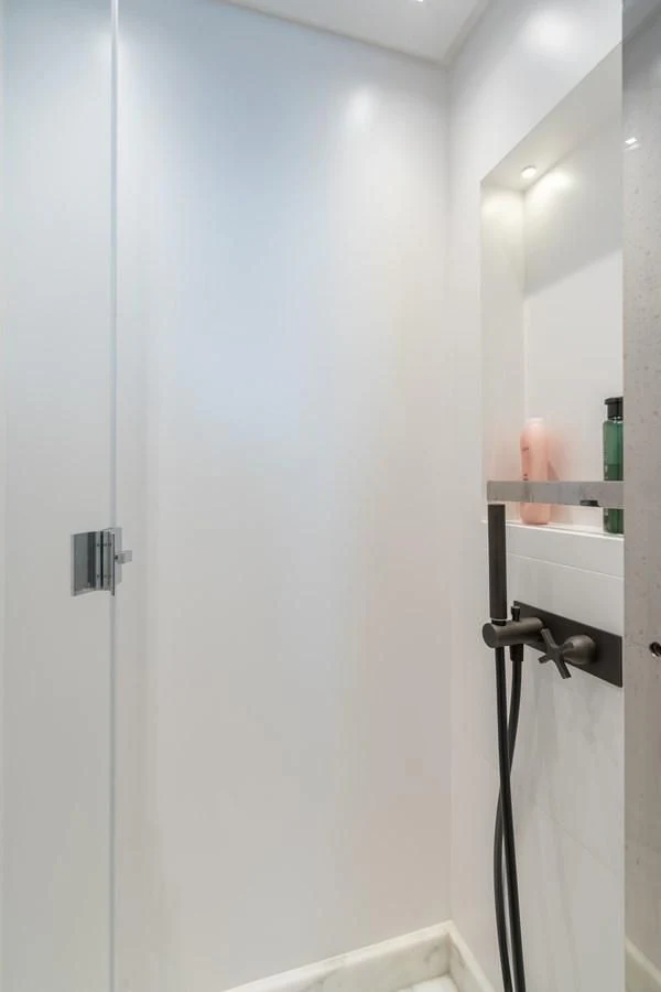 a white wall with a mirror aboard GATSBY Yacht for Charter