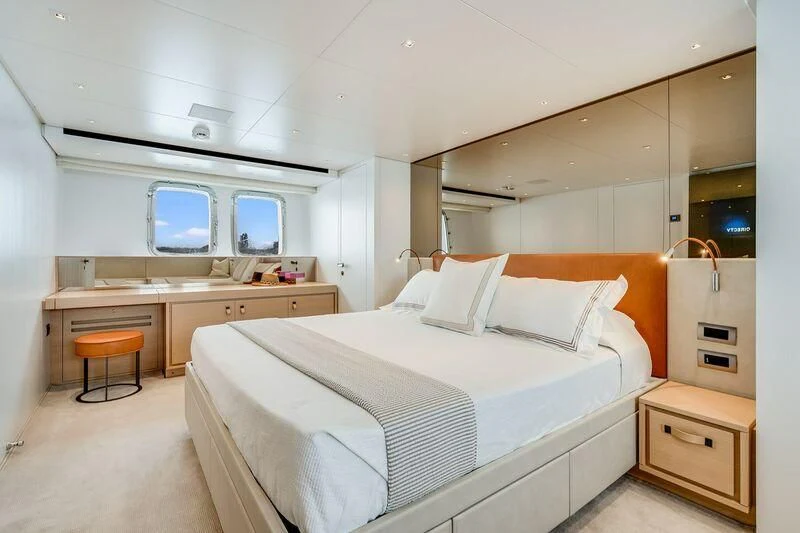 a room with a bed and a desk aboard GATSBY Yacht for Charter