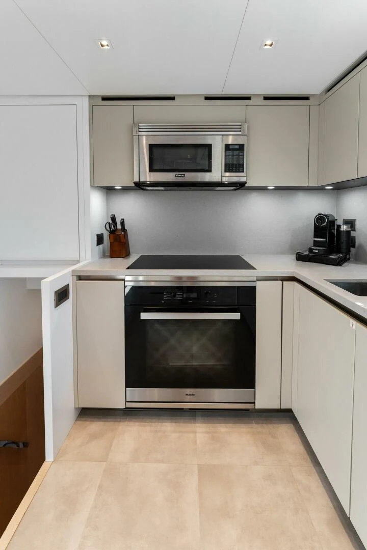 a kitchen with white cabinets aboard GATSBY Yacht for Charter