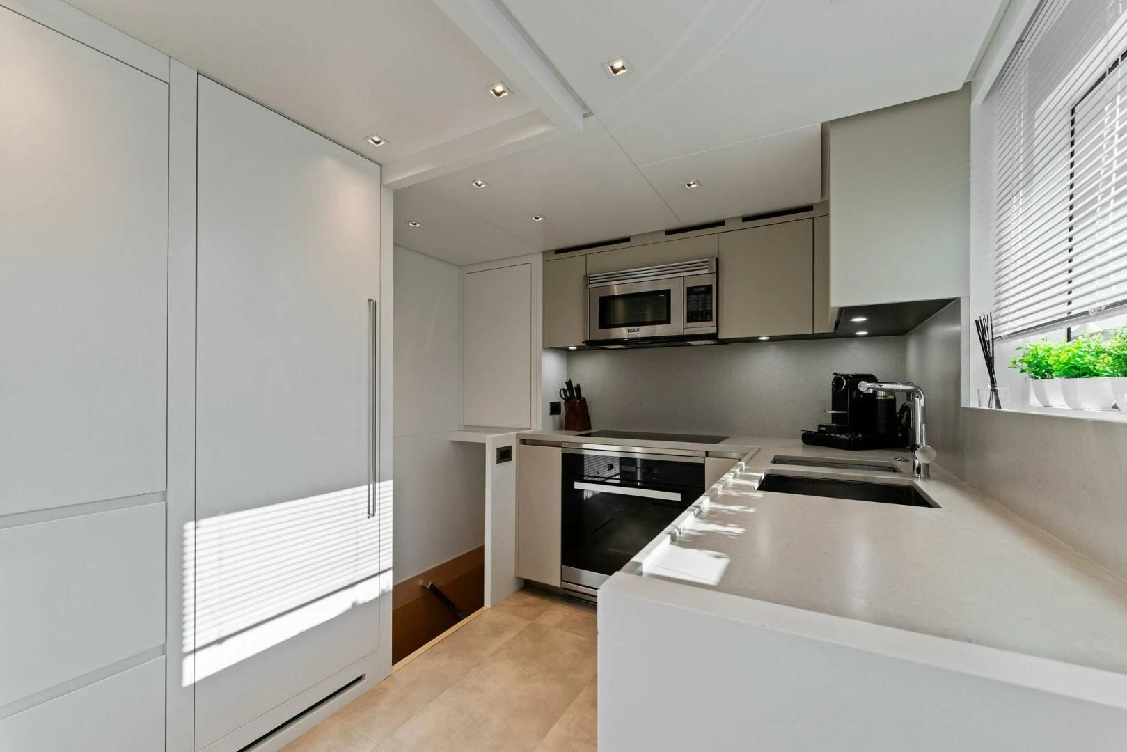 a kitchen with white cabinets aboard GATSBY Yacht for Charter