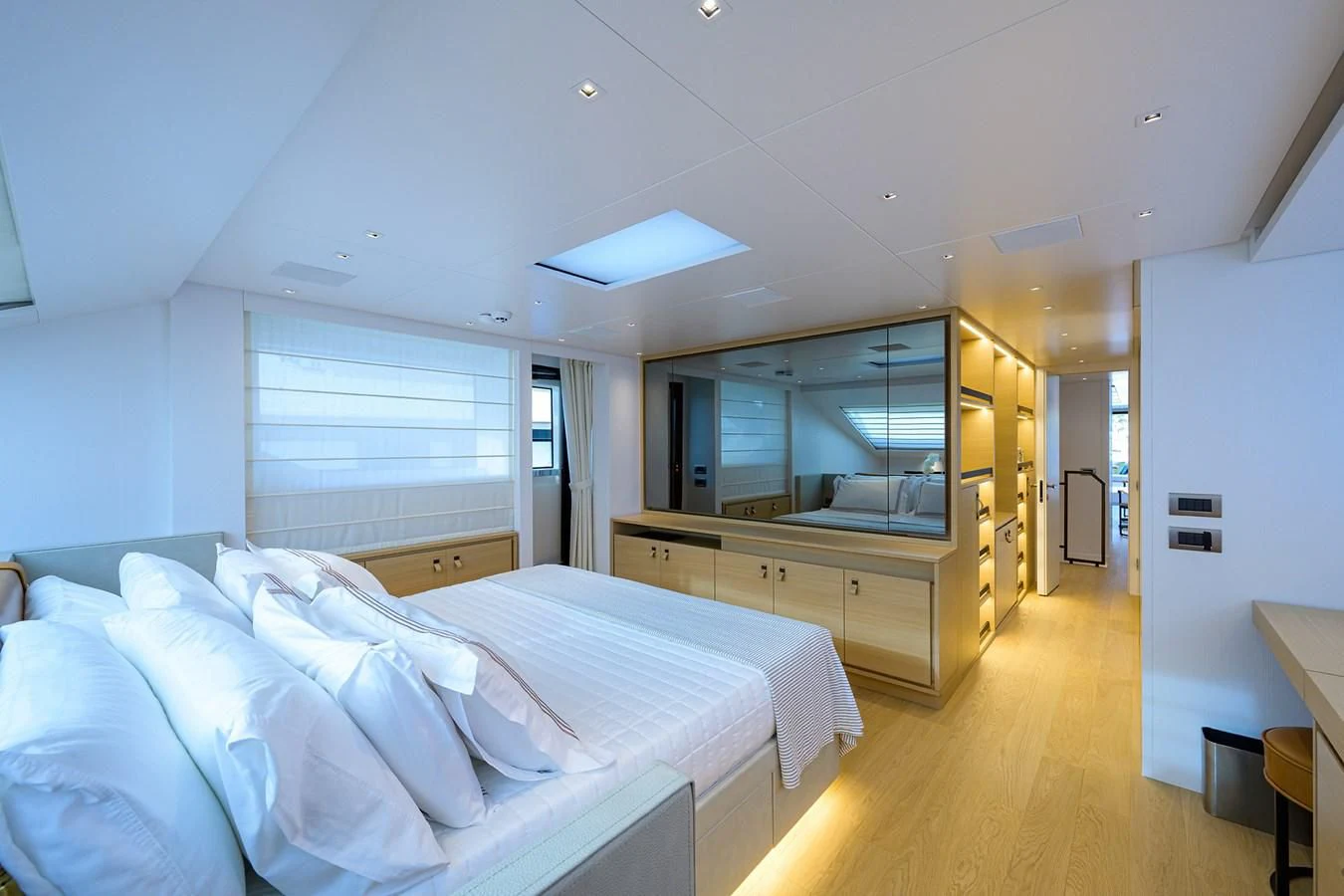 a bedroom with a bed and a large window aboard GATSBY Yacht for Charter