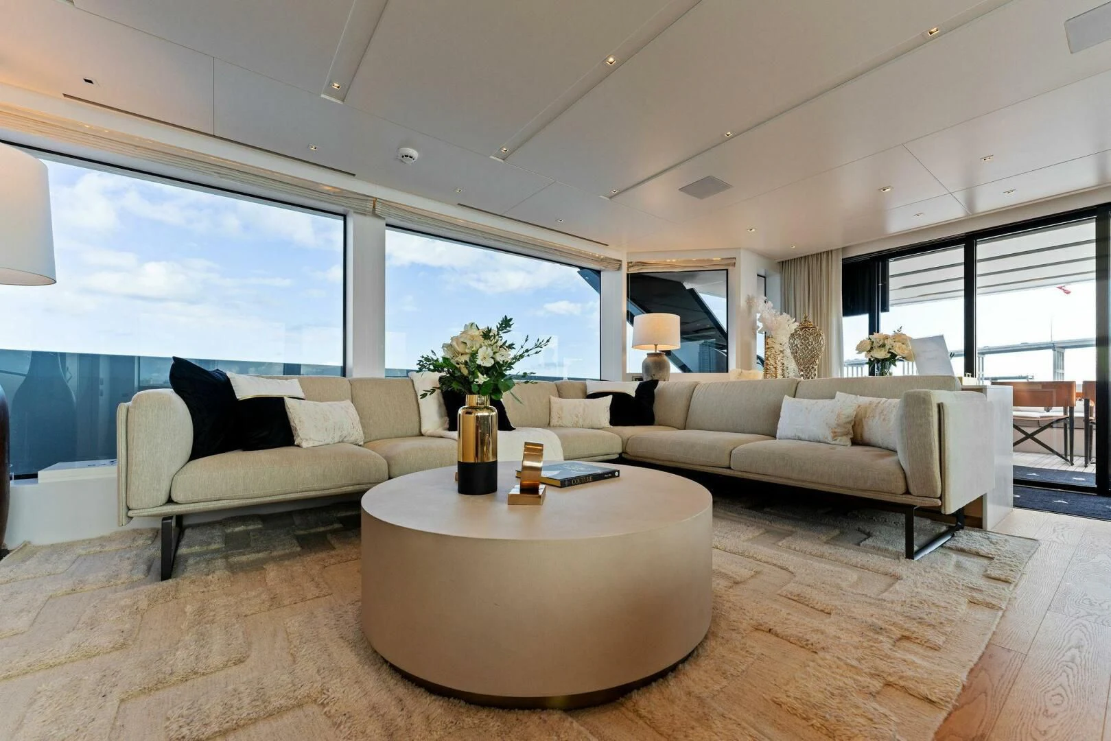 a living room with a couch and a table aboard GATSBY Yacht for Charter