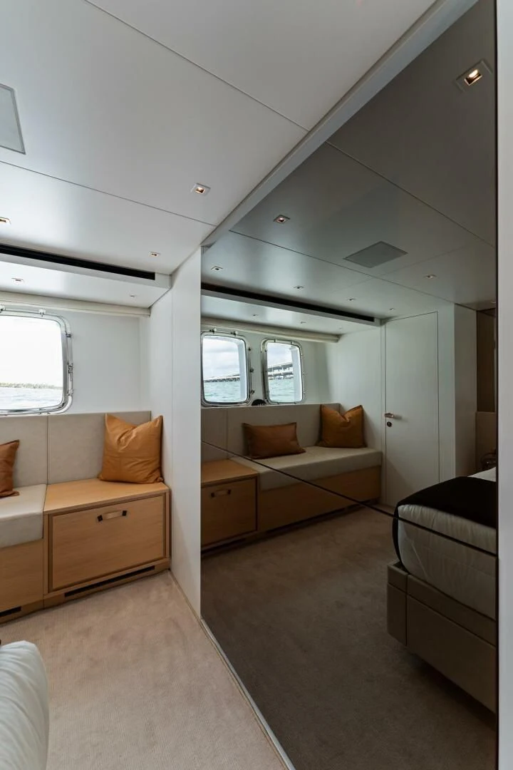 a room with a bed and a couch aboard GATSBY Yacht for Charter