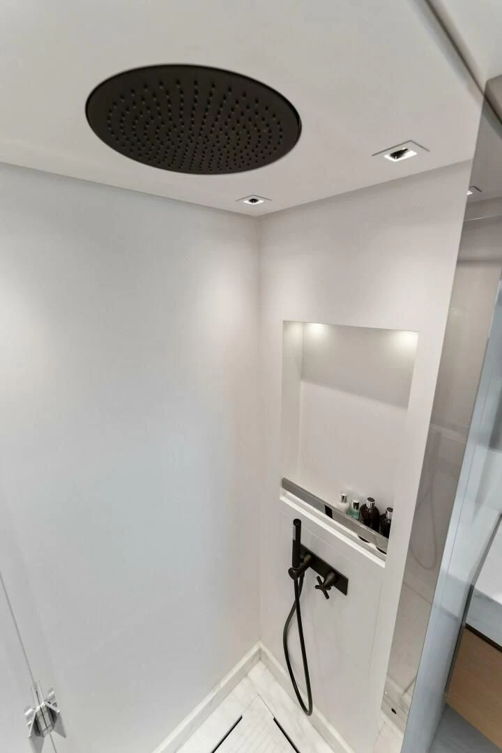 a bathroom with a round mirror aboard GATSBY Yacht for Charter