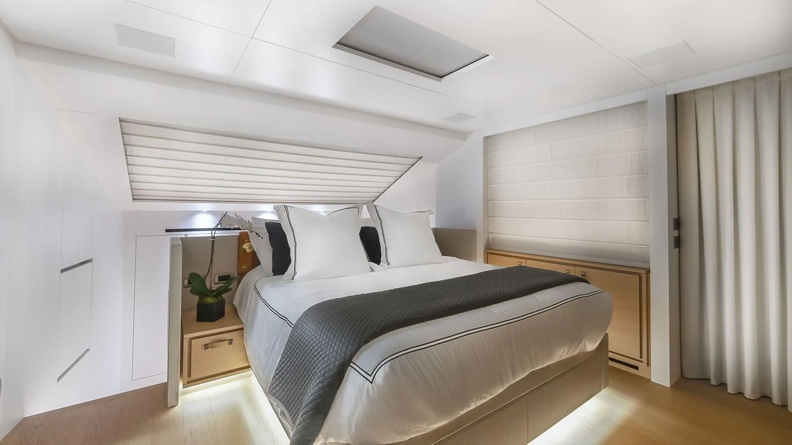 a bedroom with a bed and a desk aboard GATSBY Yacht for Charter