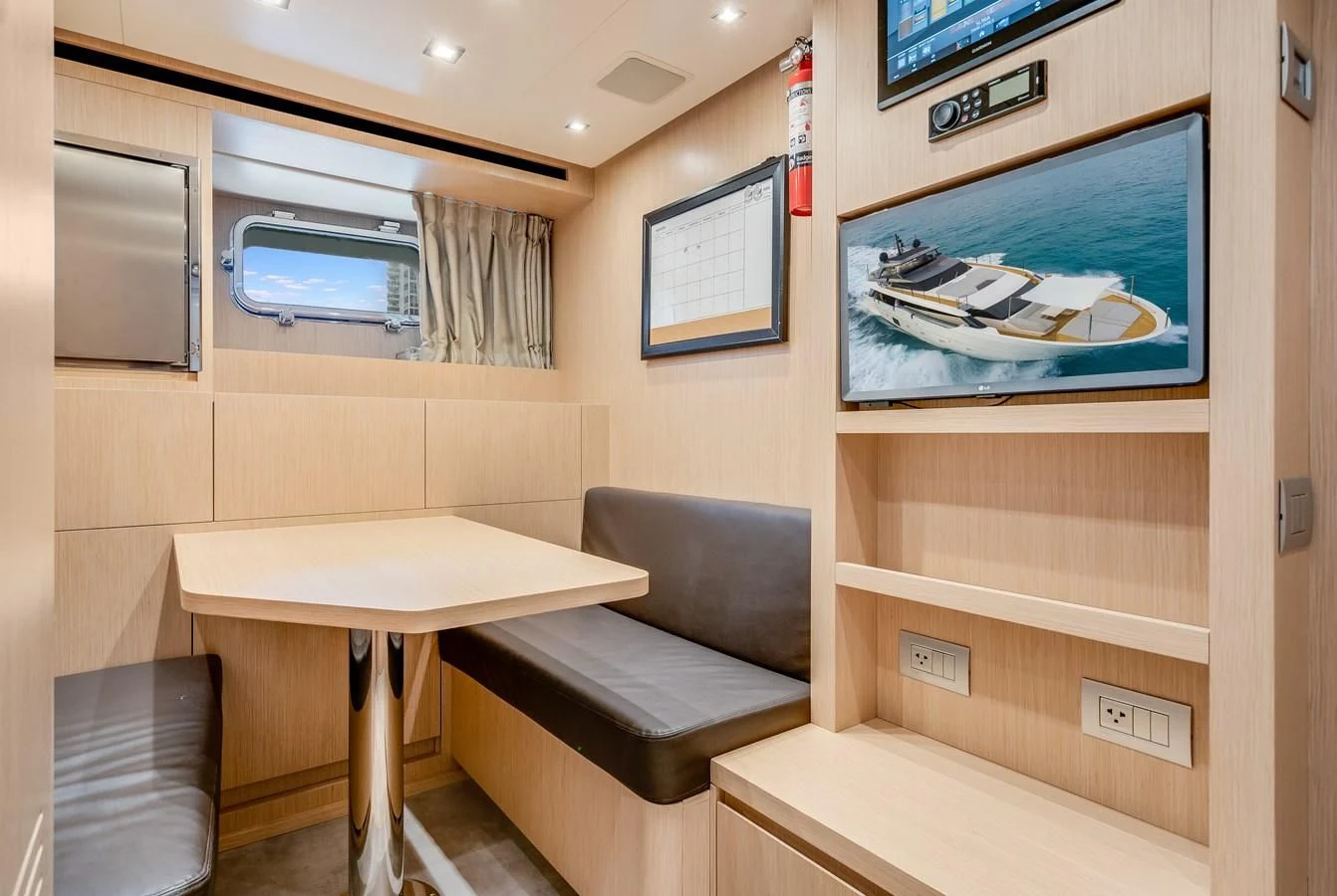 a room with a table and a couch aboard GATSBY Yacht for Charter