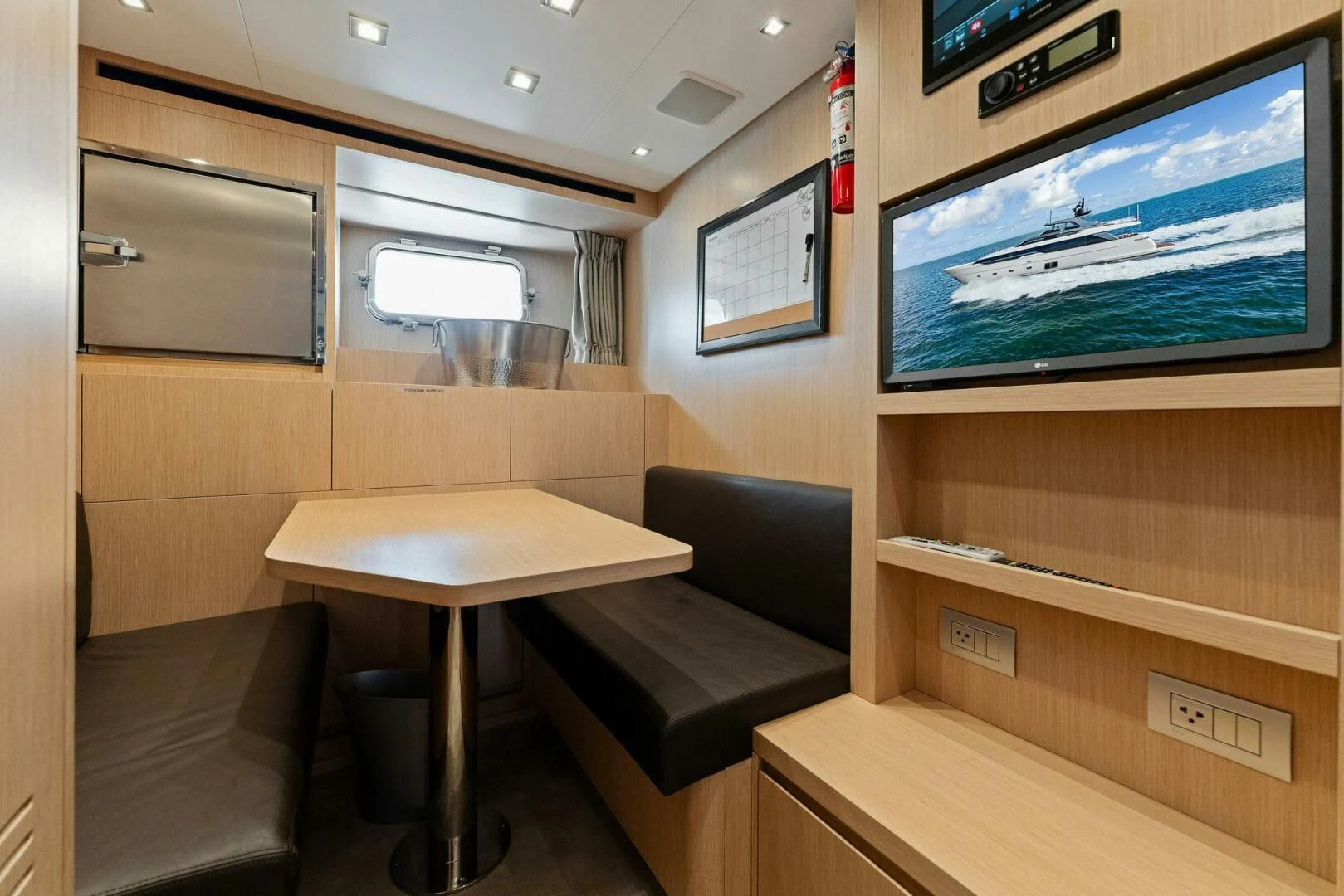 a room with a tv and a couch aboard GATSBY Yacht for Charter