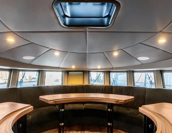 a room with tables and chairs aboard PANGAEA Yacht for Sale
