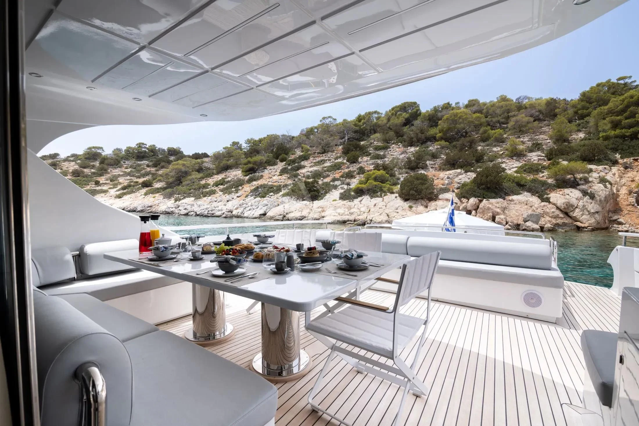 a table with chairs on it aboard MAC Yacht for Sale