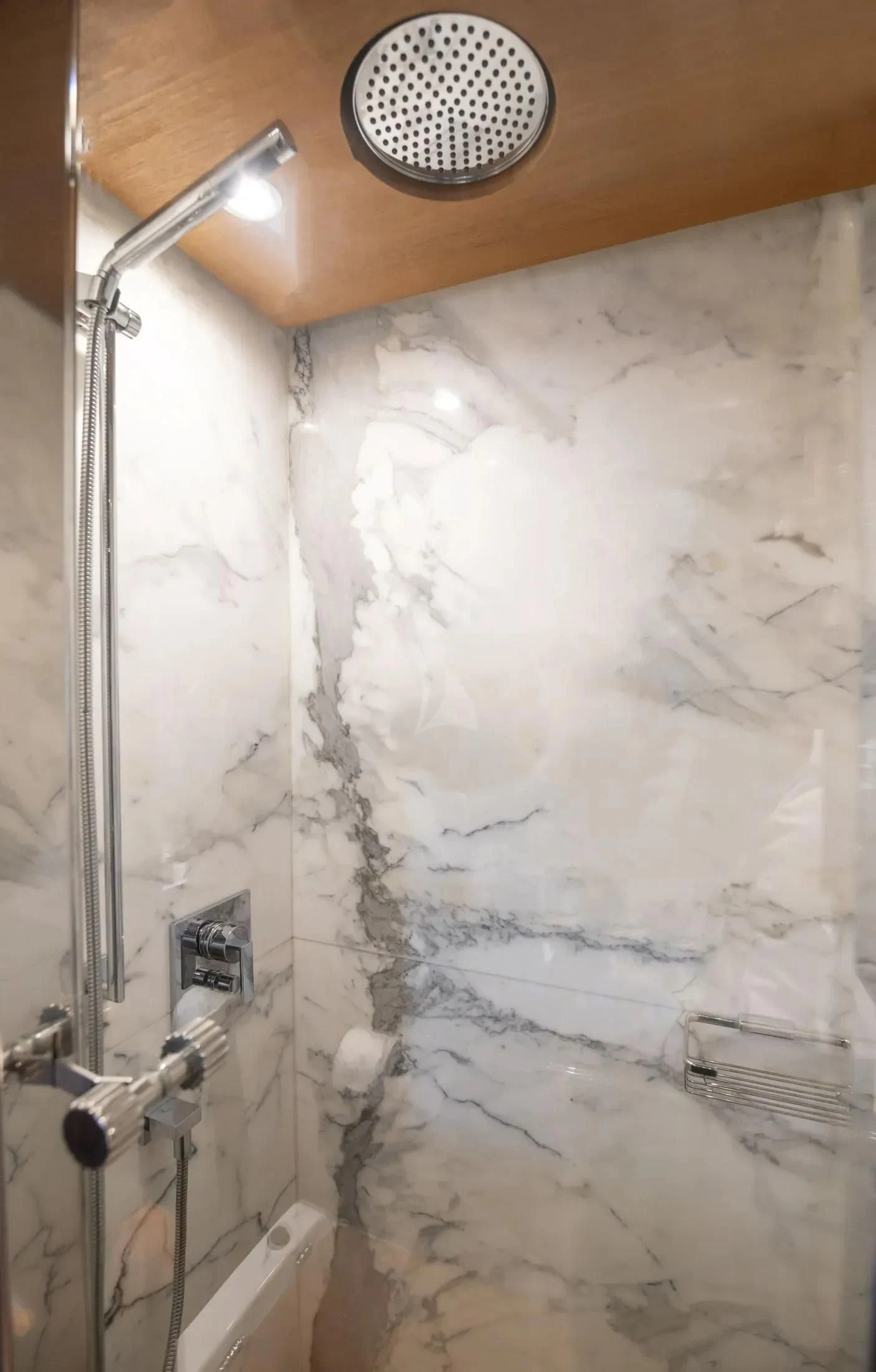 a shower with a white wall aboard MAC Yacht for Sale