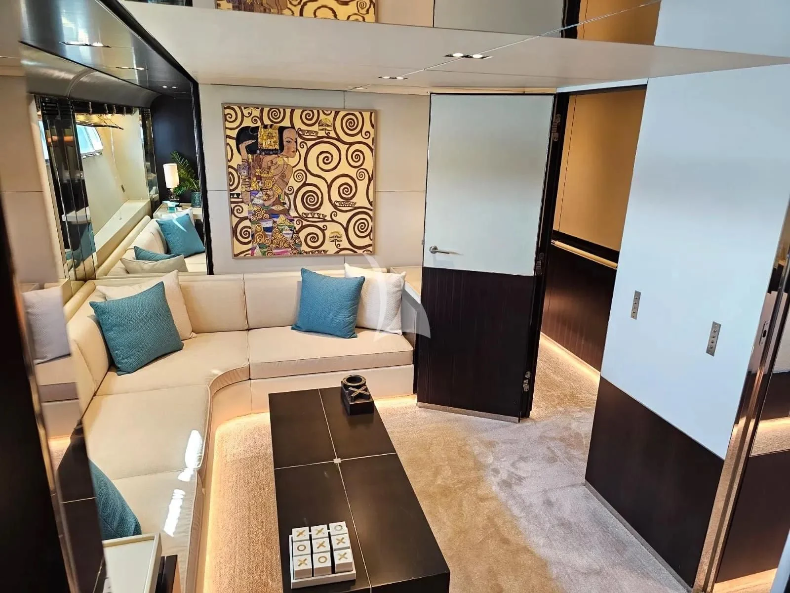 a room with a couch and a table aboard MAC Yacht for Sale
