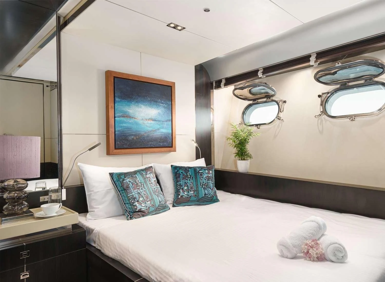 a bedroom with a large mirror aboard MAC Yacht for Sale