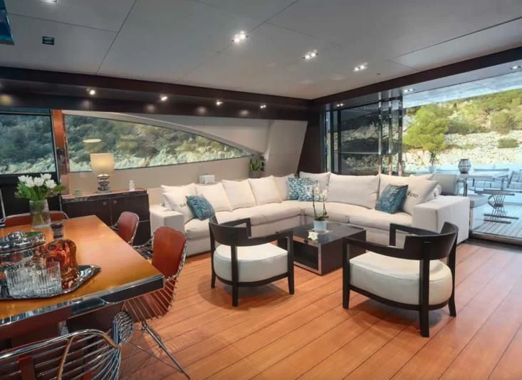 a living room with a large window aboard MAC Yacht for Sale