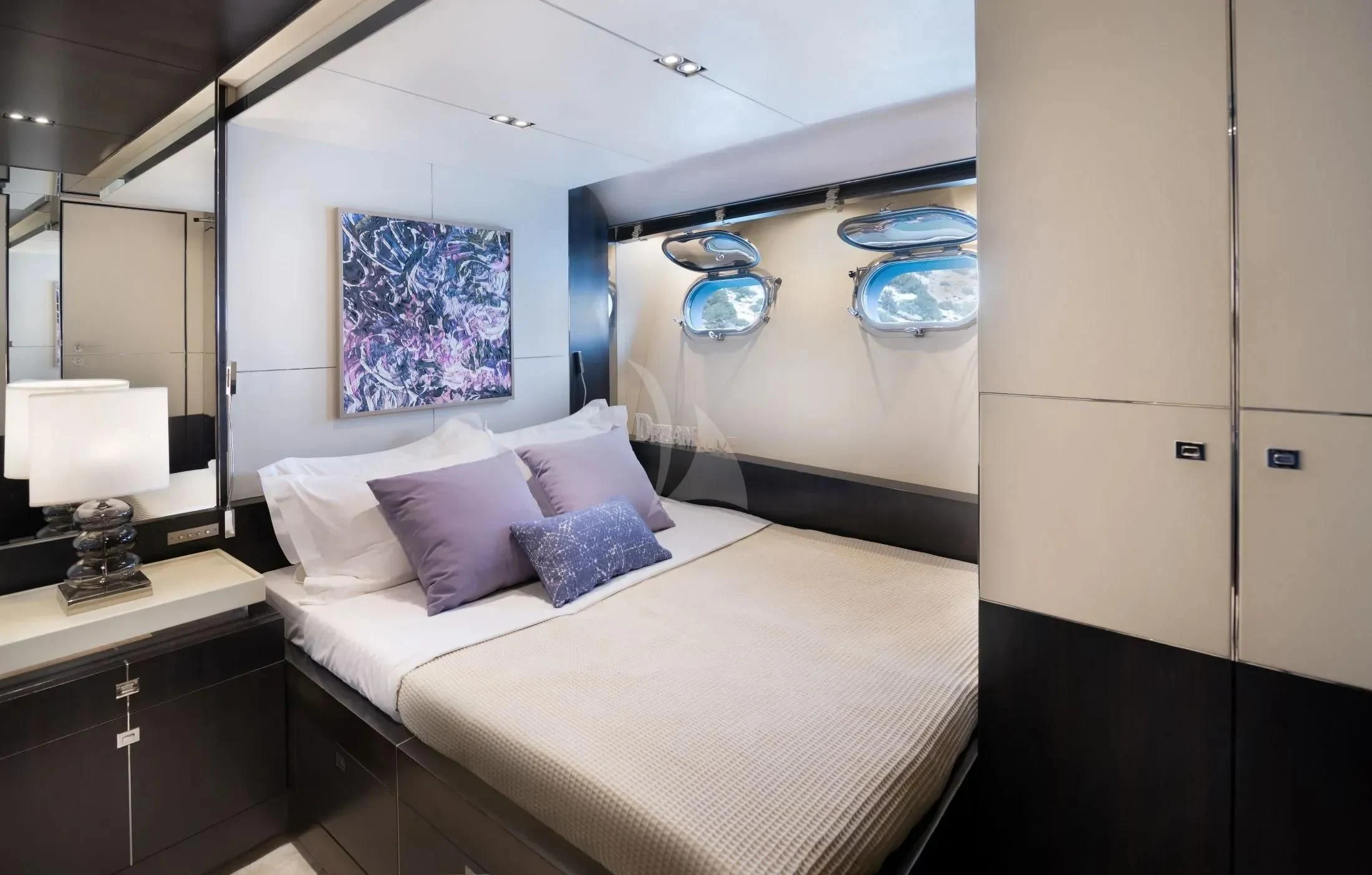 a room with a bed and a painting on the wall aboard MAC Yacht for Sale