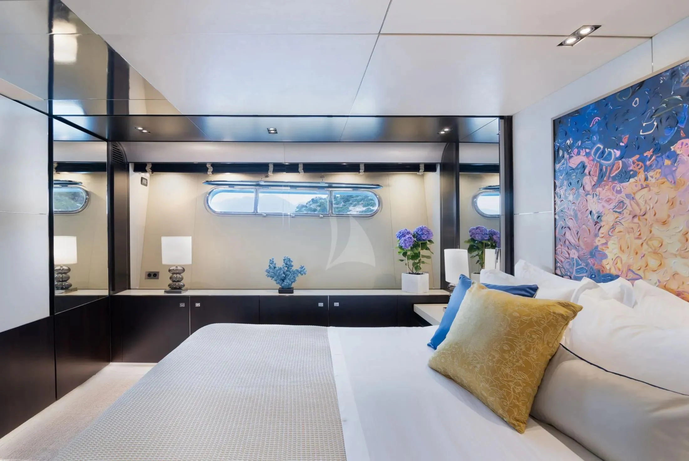 a room with a bed and a painting on the wall aboard MAC Yacht for Sale