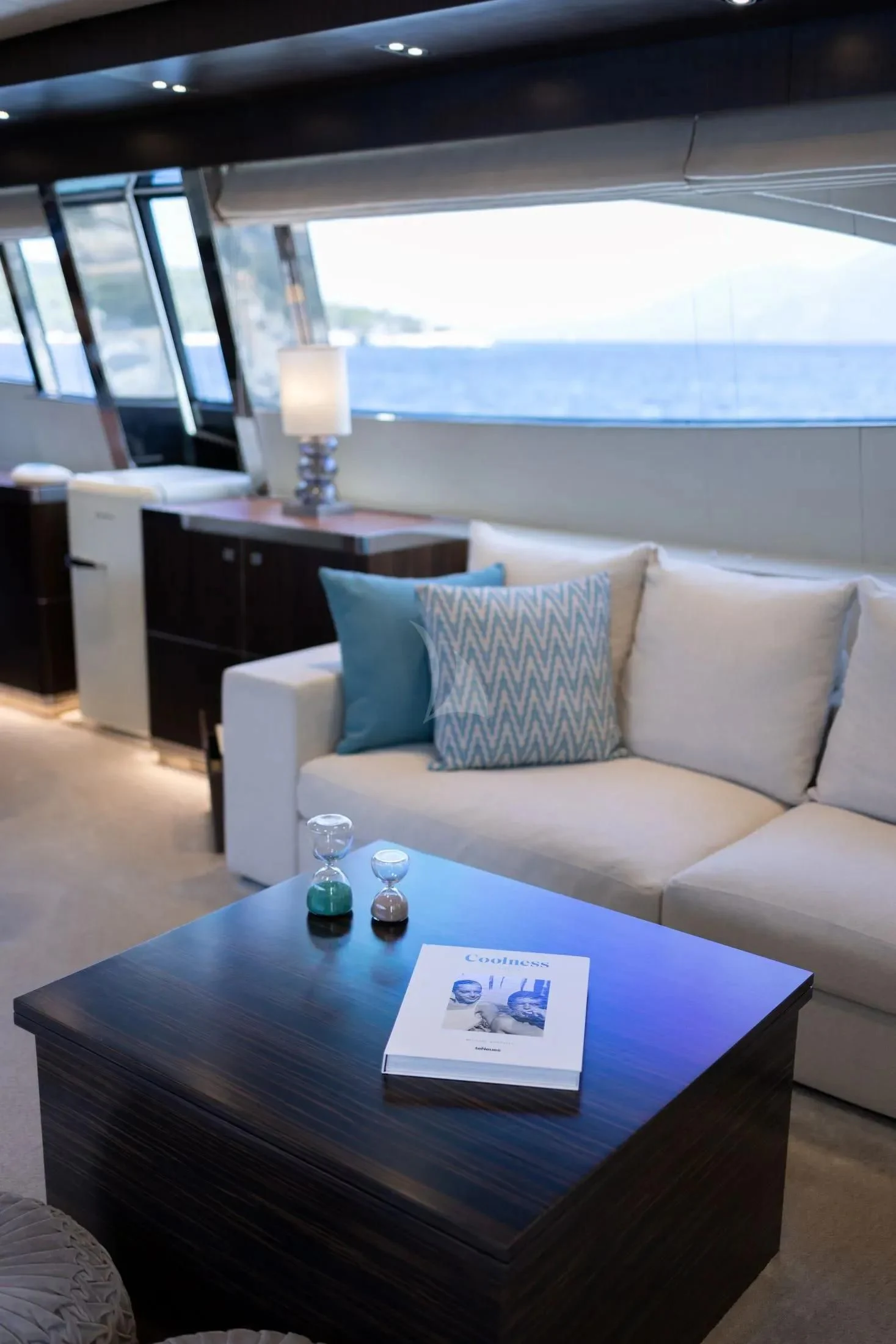 a living room with a couch and a table aboard MAC Yacht for Sale