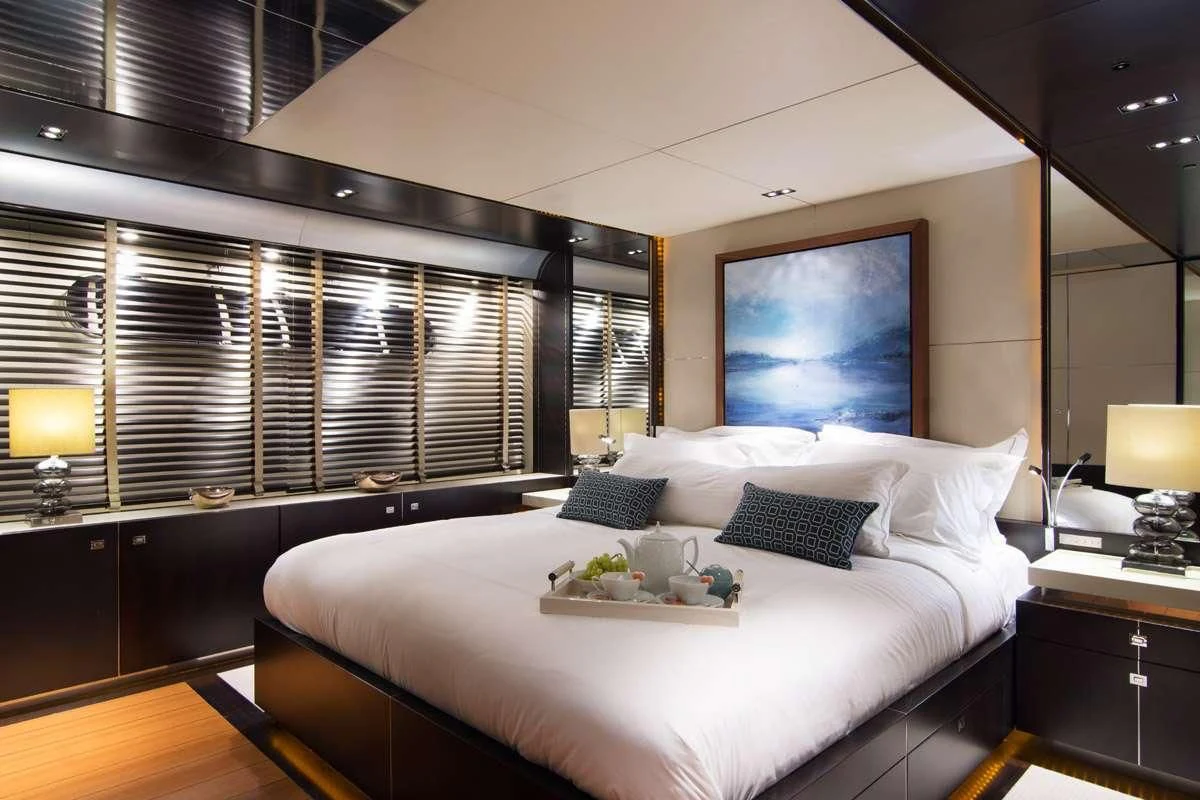 a bed with a white sheet and pillows aboard MAC Yacht for Sale
