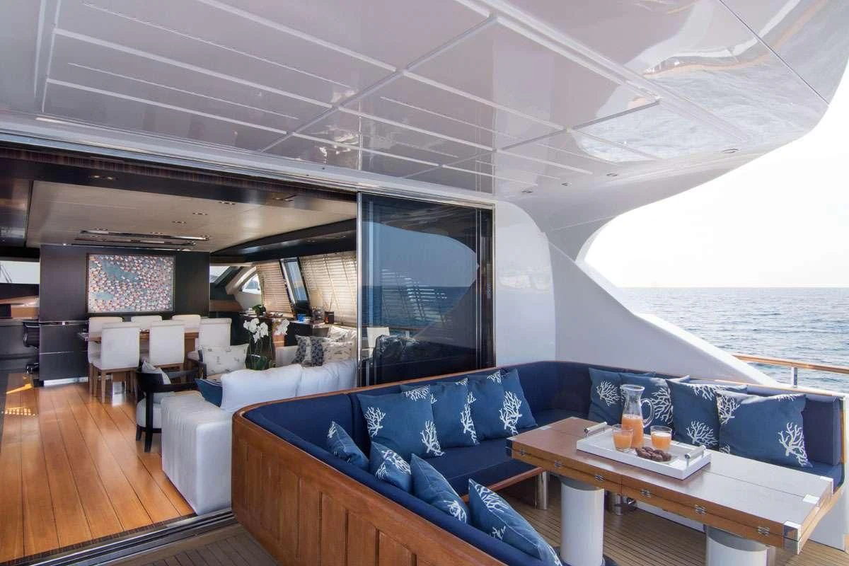 a room with a couch and a table and a large window aboard MAC Yacht for Sale