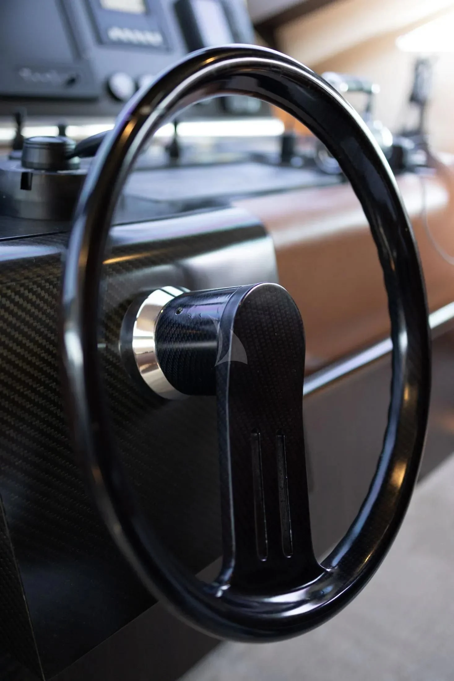 a close-up of a steering wheel aboard MAC Yacht for Sale