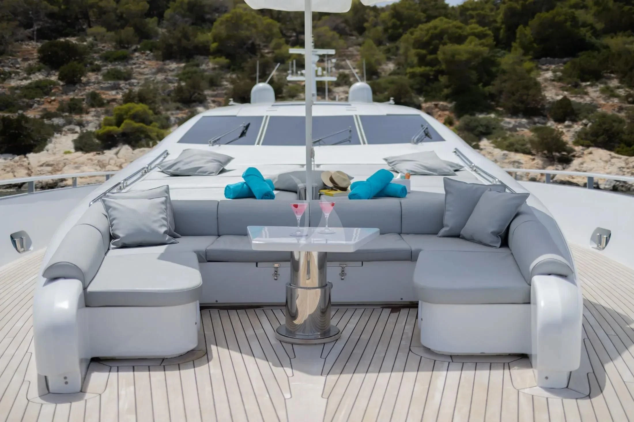 a white lounge chair with a white table and a white table with a white tablecloth and a aboard MAC Yacht for Sale