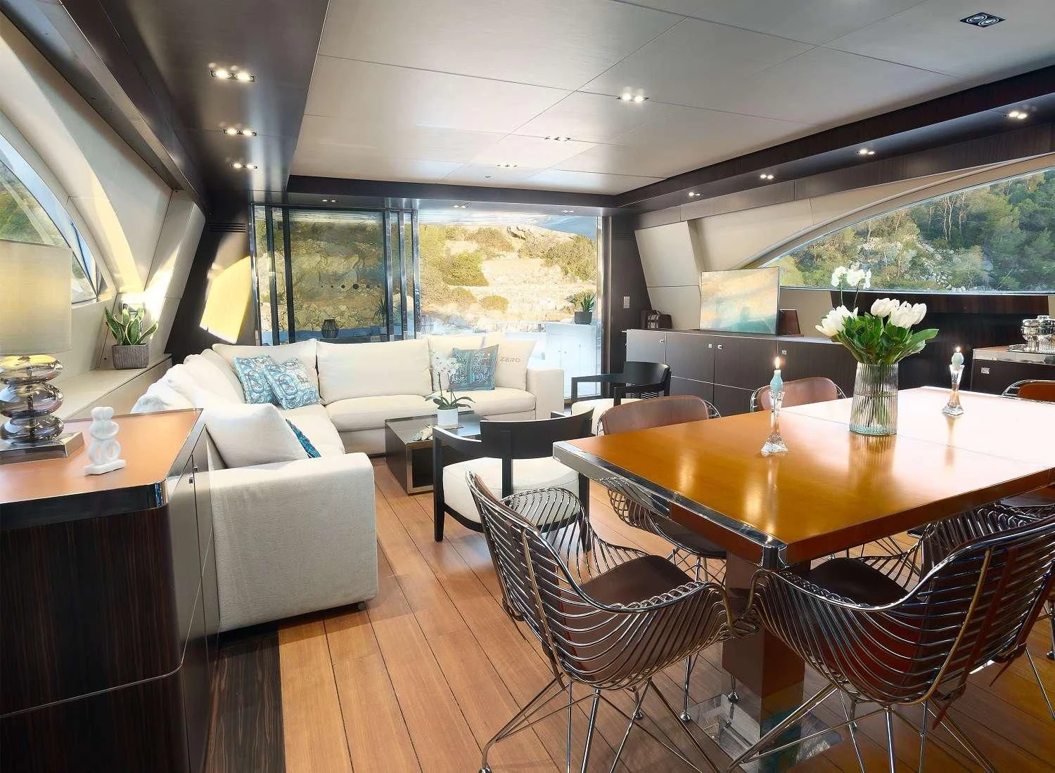 a room with a table chairs and a couch aboard MAC Yacht for Sale