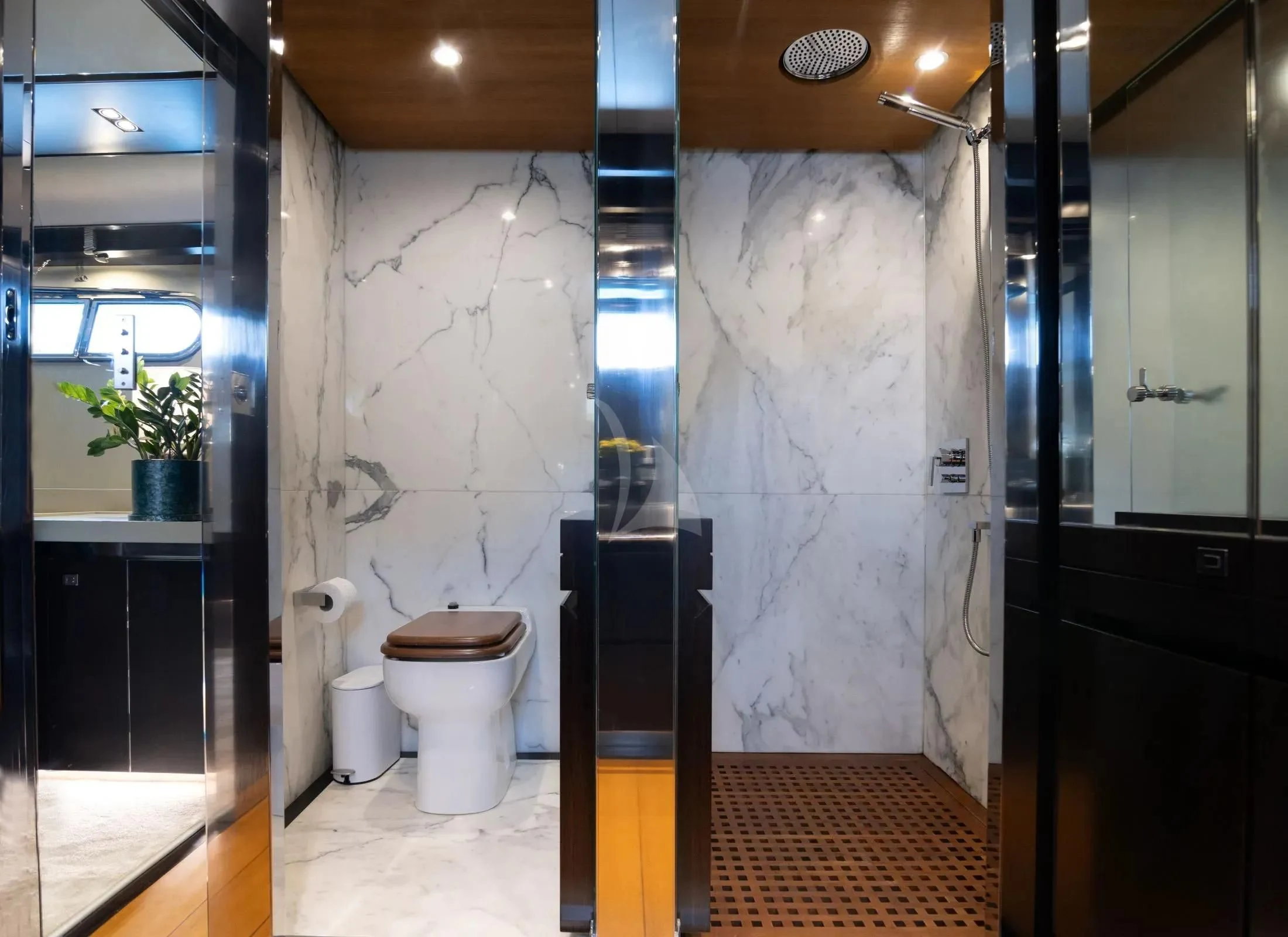 a bathroom with a toilet and a shower curtain aboard MAC Yacht for Sale